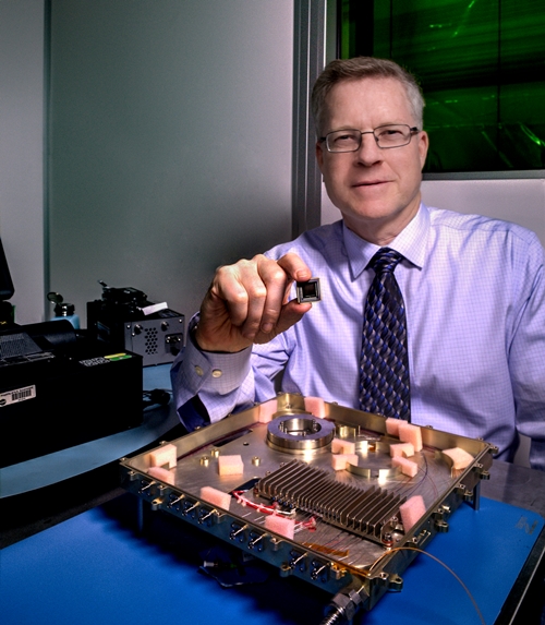 NASA laser expert Mike Krainak and his team plan to replace portions of this fiber-optic receiver with an integrated-photonic circuit, whose size will be similar to the chip he is holding here. The team then plans to test the advanced modem on the International Space Station. Photo: NASA/W. Hrybyk