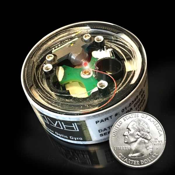 KVH's compact fiber-optic gyro (FOG) could become a key component in driverless cars. In this image, the red illumination represents light moving through the FOG's optical circuit of coiled fiber. KVH explains that this circuit is the FOG's sensing unit, mounted with power and processing electronics within a driverless car to provide precise data for the car's navigation systems. Photo: KVH Industries.