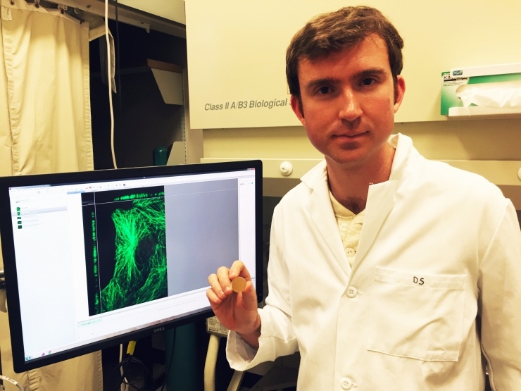 Georgia Tech graduate student Eric Alonas, holding a mirror of the type that the multi-national collaboration used to improve STED super-resolution microscopy. Photo: John Toon/Georgia Tech.