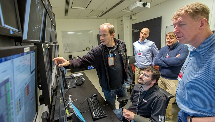 HAPLS team members (from left) Constantin Haefner, Jiri Thoma, James Nissen (sitting), Pavel Bakule and Bedrich Rus review the results of pump laser commissioning tests in the HAPLS control room. Photo by Jason Laurea/LLNL.