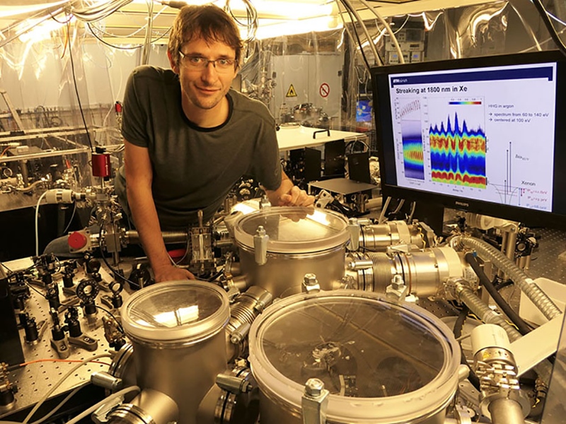 Pictured here is Thomas Gaumnitz, a postdoctoral fellow in the research group of ETH professor Hans Jakob W&ouml;rner, showing the experimental setup that generates the shortest laser pulses ever measured. Photo: ETH Zurich.
