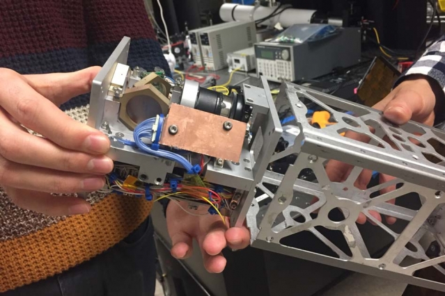 A new laser-pointing platform developed at MIT may help launch miniature satellites called CubeSats into the high-rate data game.  Photo: Jennifer Chu.