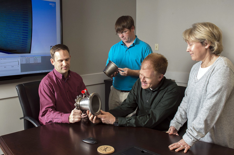 Engineers from NASA Marshall Space Flight Center's Propulsion Department examine nozzles fabricated using a freeform-directed energy wire deposition process. From left are Paul Gradl, Will Brandsmeier, Ian Johnston and Sandy Greene, with the nozzles, which were built using a NASA-patented technology that has the potential to reduce build time from several months to several weeks. Credits: NASA/MSFC/Emmett Given.