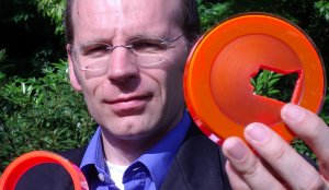 Researcher holding polymer disc