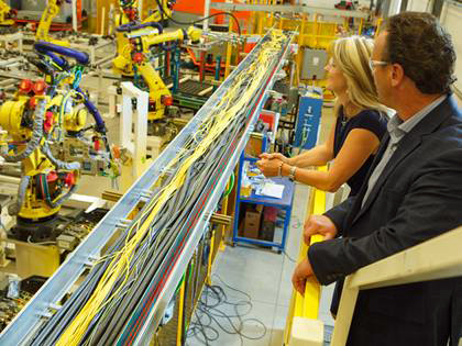 Carolyn Garvey and Don Leslie, CEOs of Prodomax, observe a production line.