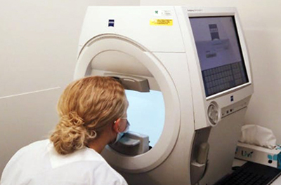 A patient takes a visual field test on the Carl Zeiss Meditec HFA3. 