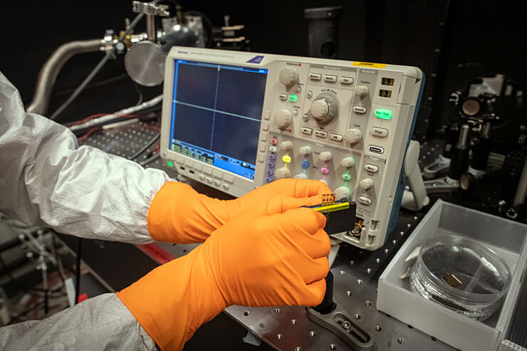 Chunxiong Bao in the laboratory with the tiny transceiver.