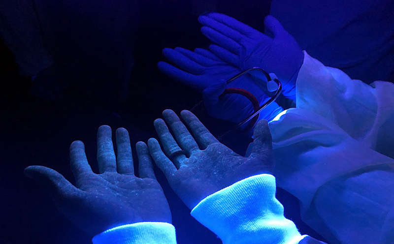 Tell-tale fluorescent liquid visible on healthcare workers’ skin.