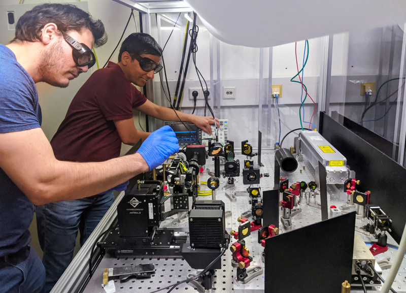 Carlos Saavedra (left) and Deepak Pandey prepare the optical microfilter.