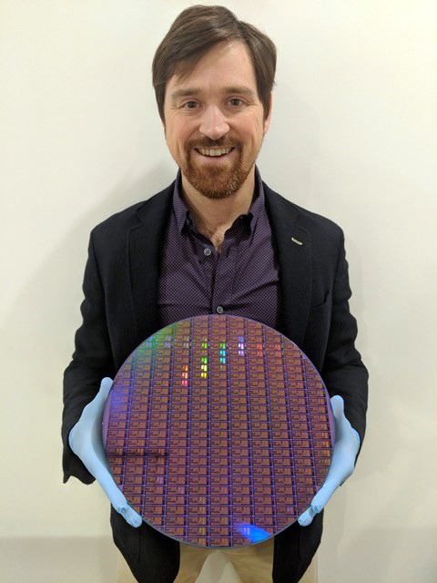 Dr. Chad Husko, CEO and founder of Iris Light tech, with a 300 mm silicon wafer.