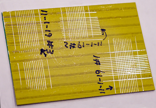 Primer-coated specimen shows marks from the laser system. 