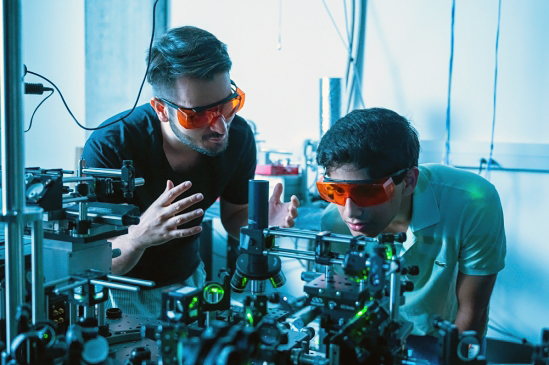 Kamyar Parto (left) works in the Quantum Photonics Lab with student Arjun Choudhri.