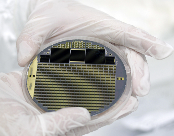 Solar cell wafer with four-junction concentrator cells and test structures.