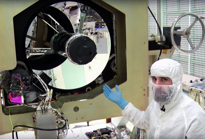 An ATLAS engineer works on the 1m-wide beryllium telescope.