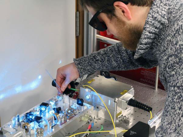 Birmingham PhD student Tadas Pyragius aligns a laser frequency doubling cavity.