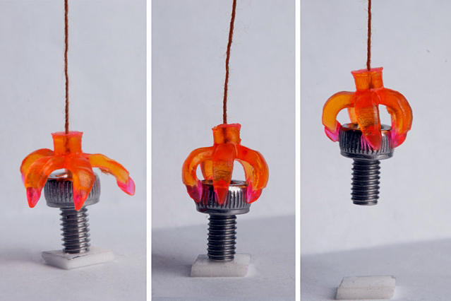 A 3-D printed multimaterial shape-memory mini-gripper grasps a cap screw.