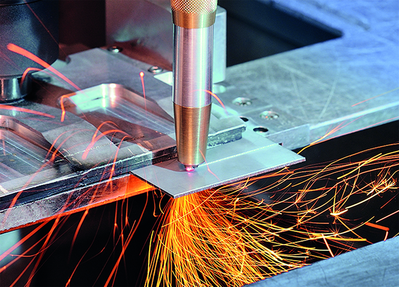 Laser cutting head with diamond optics has water cooling and shield gas supply. 
