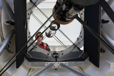 ANU instrument scientist Celine d'Orgeville with an EOS 1.8m telescope.