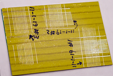 Primer-coated specimen shows marks from the laser system. 