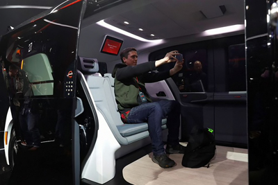 A launch attendee takes a selfie inside a Cruise Origin autonomous vehicle in 2020.