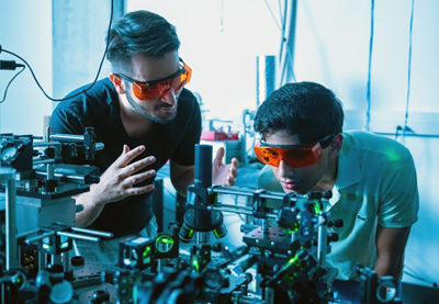 Kamyar Parto (left) works in the Quantum Photonics Lab with student Arjun Choudhri.
