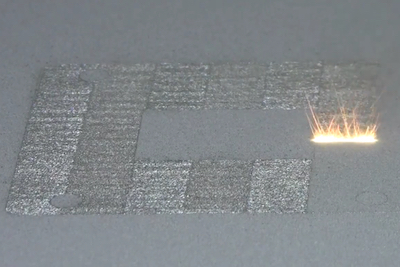 3D printer of the laser powder-bed fusion type, in action.