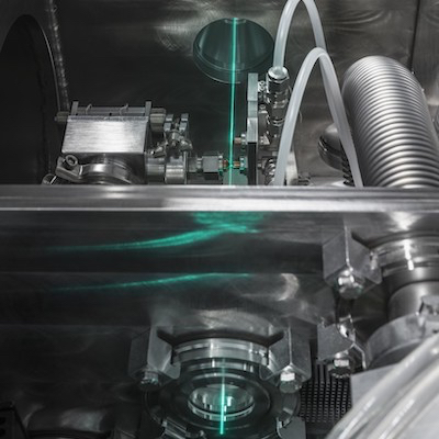A high-power laser is converted to EUV by high harmonic generation.