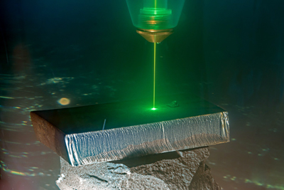 Deep cut: Short-wavelength green laser cutting steel in the sea.