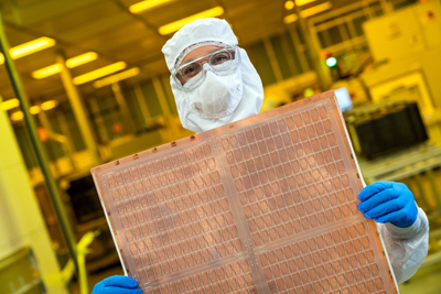 An Intel engineer holds a test glass core substrate panel.