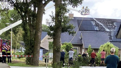 A fire on a building equipped with solar panels. 