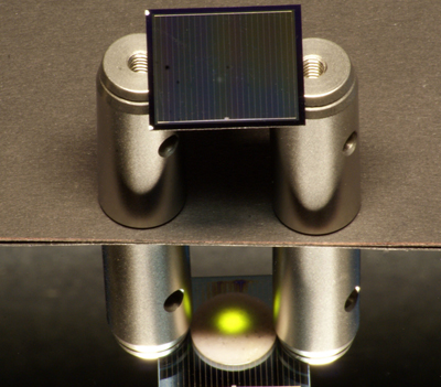 A two-sided silicon solar cell illuminated by an infrared laser.