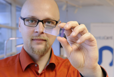 Dispelix researcher Antti Sunnari with a sample of the display.